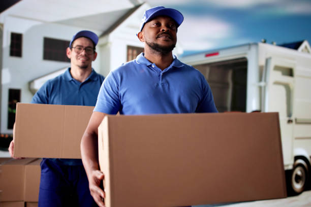 Professional Movers Relocating House, Loading Van With Furniture Boxes.
